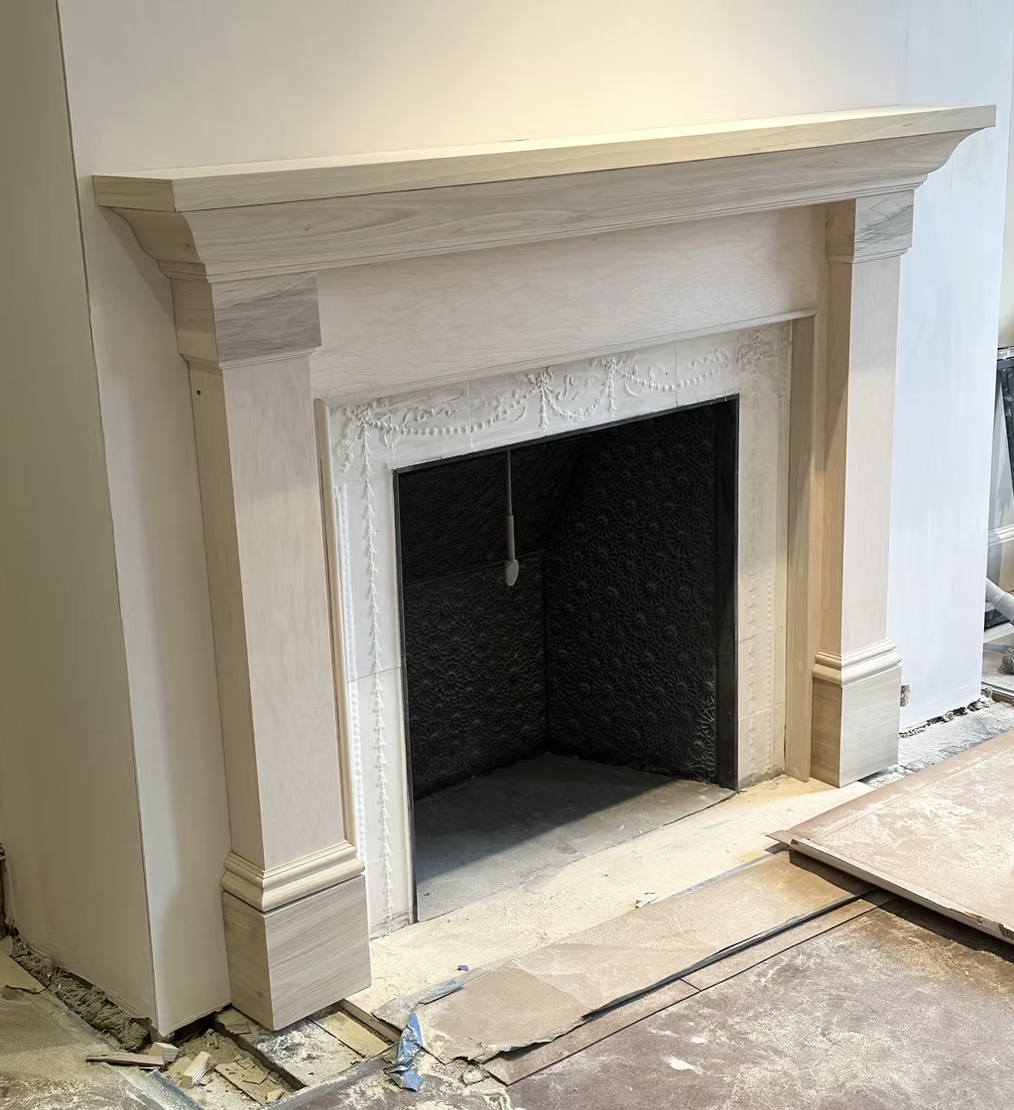 Elegant white painted fireplace mantel with detailed molding